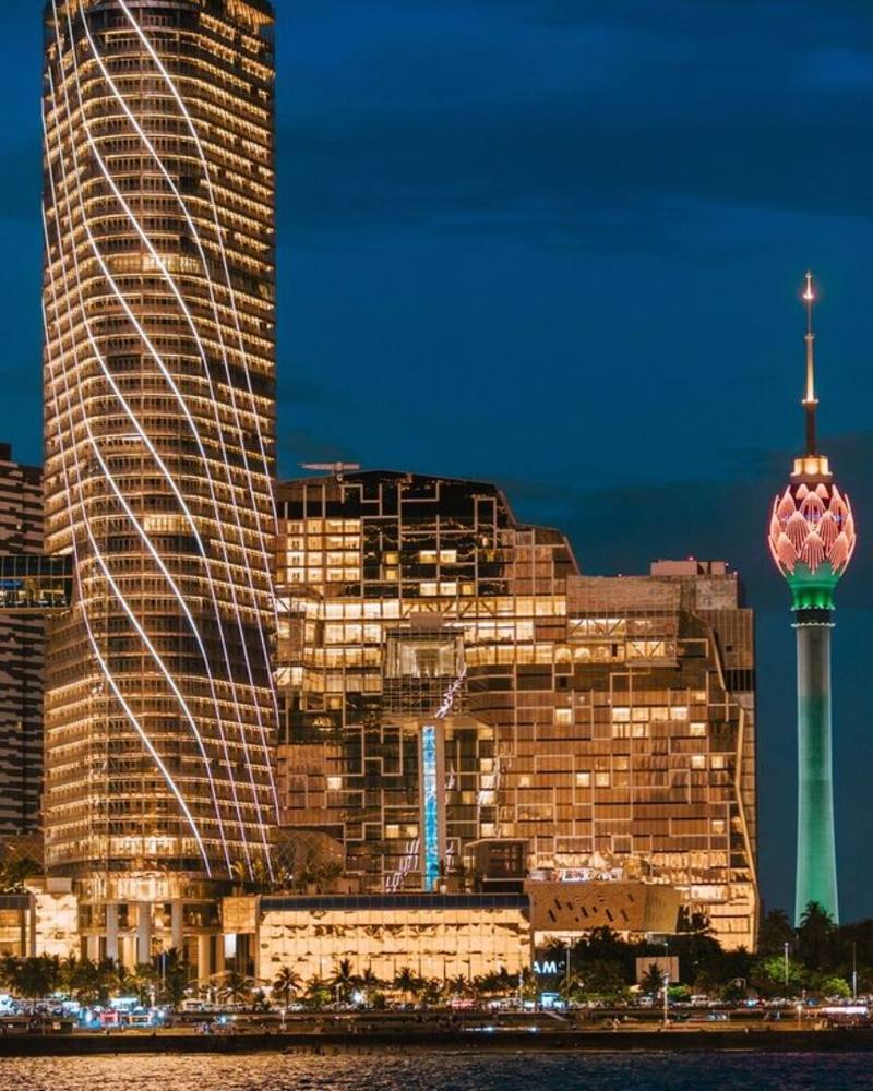Illuminated towers and the Lotus Tower on the waterfront skyline at night, Colombo, Sri Lanka