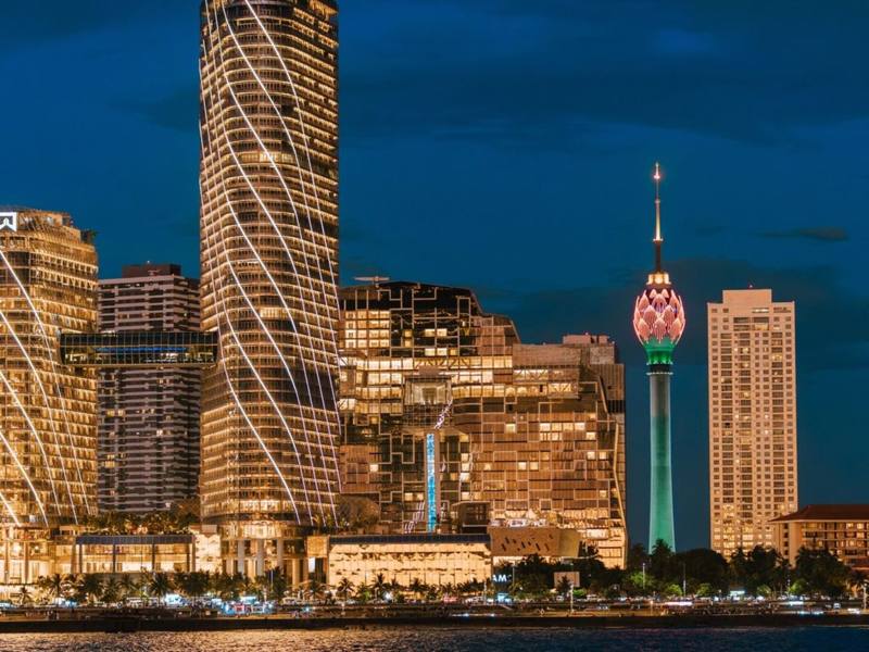 Illuminated towers and the Lotus Tower on the waterfront skyline at night, Colombo, Sri Lanka