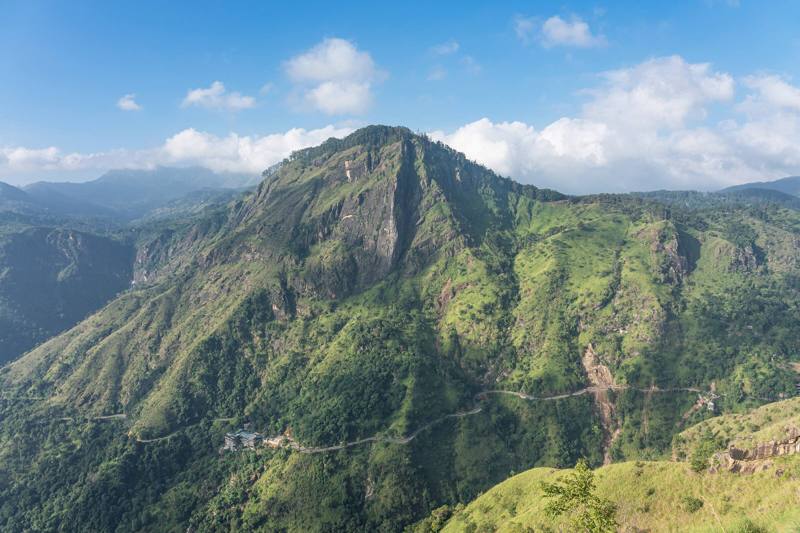 Ella Rock rising above green valleys under a blue sky, seen from Little Adam’s Peak, Ella, Sri Lanka