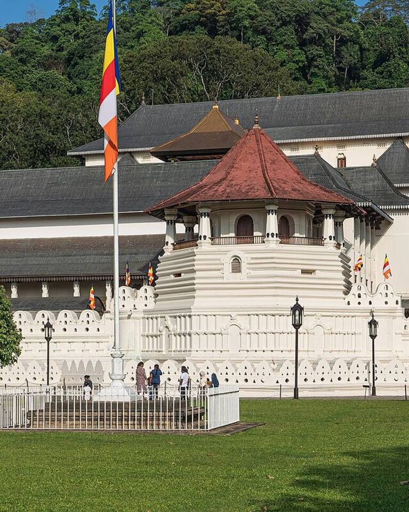 White walls and red-roofed octagon of the Temple of the Sacred Tooth Relic, Kandy, Sri Lanka