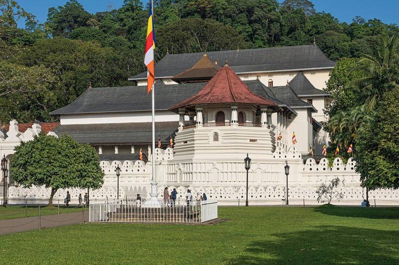 White walls and red-roofed octagon of the Temple of the Sacred Tooth Relic, Kandy, Sri Lanka