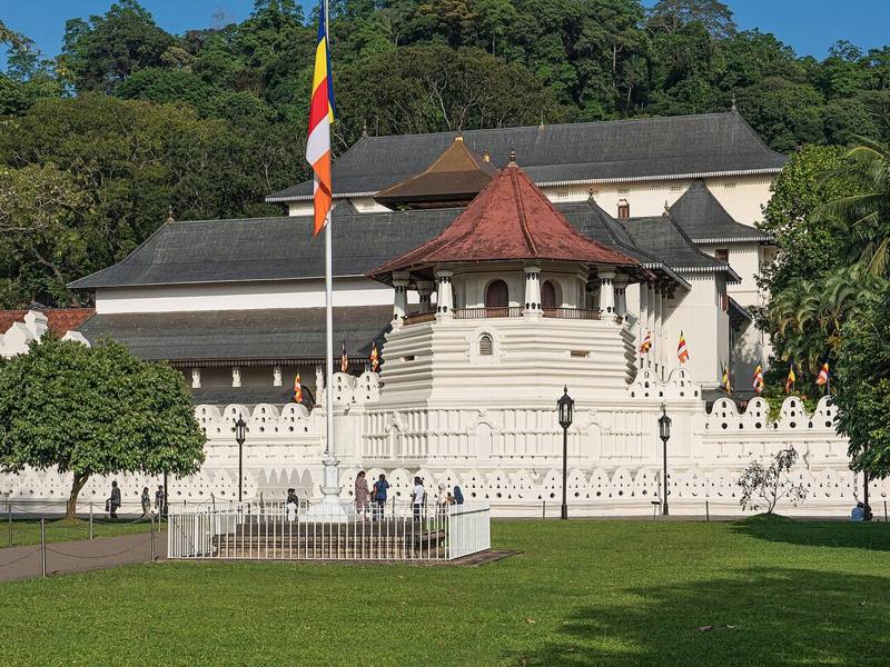 White walls and red-roofed octagon of the Temple of the Sacred Tooth Relic, Kandy, Sri Lanka
