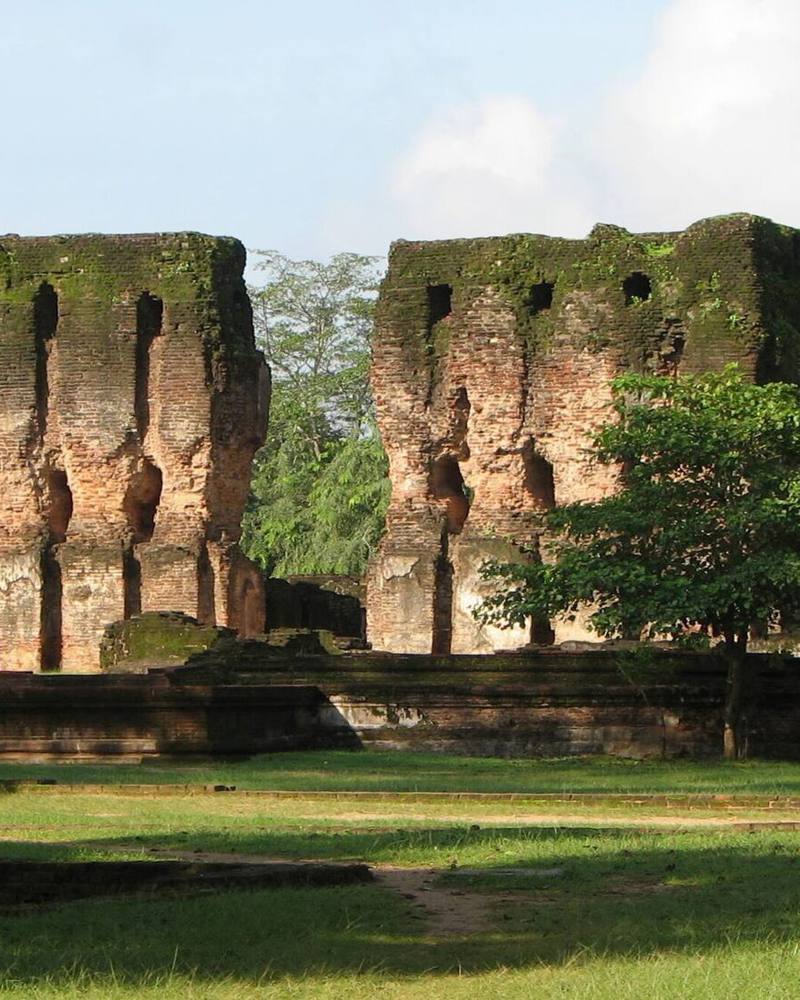Brick walls of the Royal Palace ruins above green lawns, Polonnaruwa, Sri Lanka