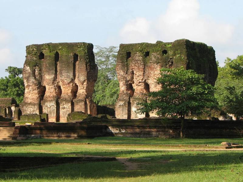 Brick walls of the Royal Palace ruins above green lawns, Polonnaruwa, Sri Lanka