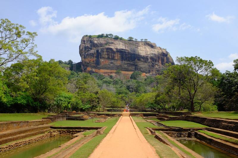Lion Rock fortress rising above the water gardens and forest, Sigiriya, Sri Lanka