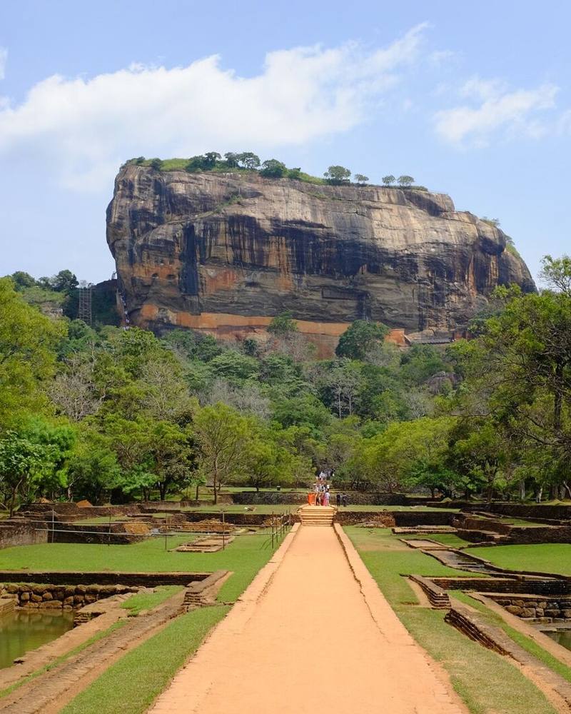 Lion Rock fortress rising above the water gardens and forest, Sigiriya, Sri Lanka
