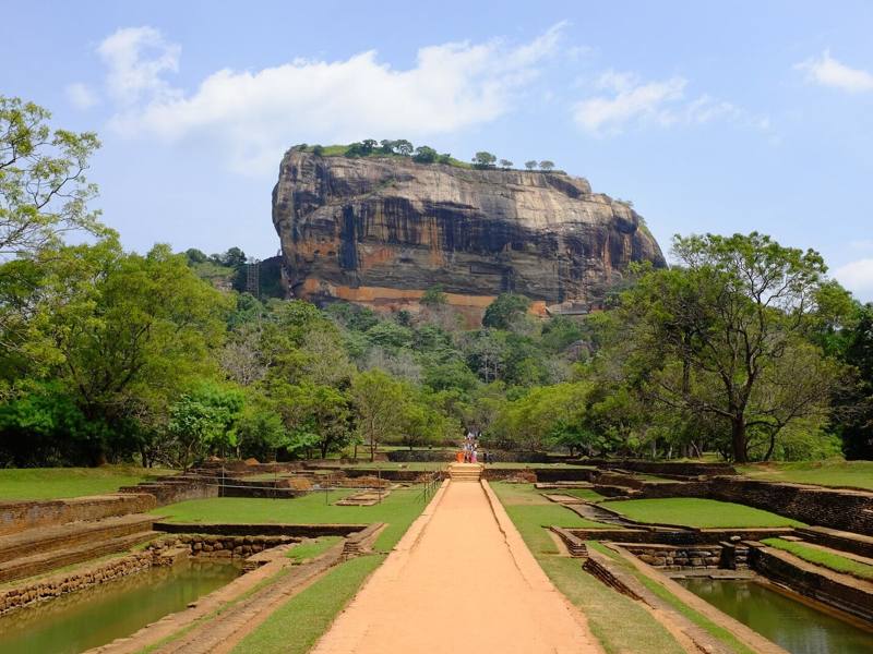 Lion Rock fortress rising above the water gardens and forest, Sigiriya, Sri Lanka