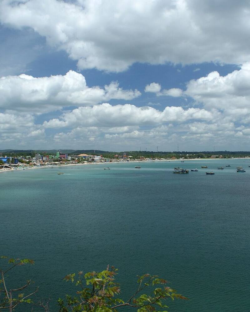 Sweeping turquoise bay dotted with boats, with the town along the shore, Trincomalee, Sri Lanka