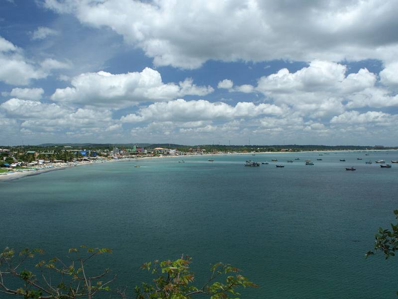 Sweeping turquoise bay dotted with boats, with the town along the shore, Trincomalee, Sri Lanka